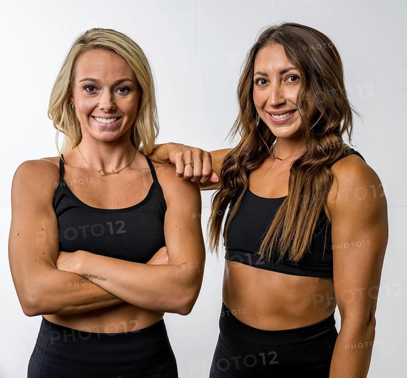 Two gorgeous athletic fit models pose confidently, their toned muscles highlighted by soft lighting. They exude strength and grace, showcasing their stunning physique in a sleek, minimalist setting, Terrell, United States of America