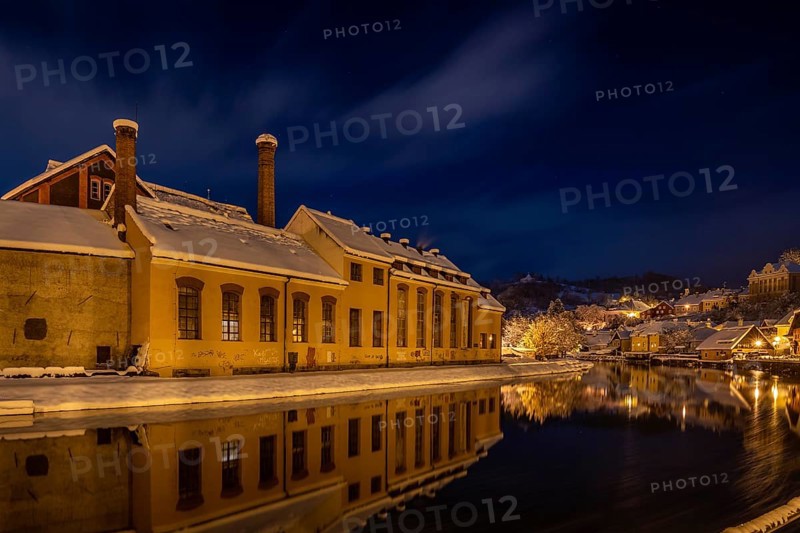Winter view of Cesky Krumlov, picturesque houses under the castle with snow-covered roofs. Narrow streets and the Vltava river. Travel and Holiday in Europe. Christmas time. UNESCO World Heritage. Czech Republic