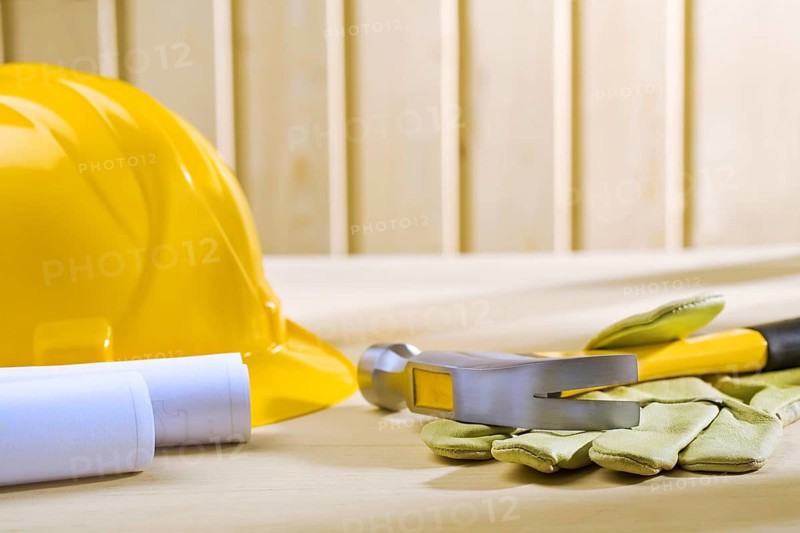Claw hammer on glove and hellmet with blueprints