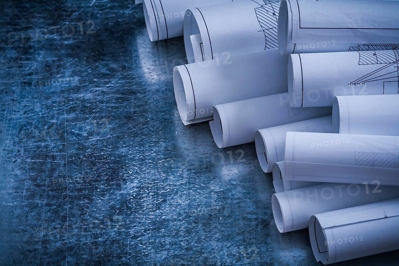 Metallic vintage background with heap of white blueprint rolls building and architecture concept