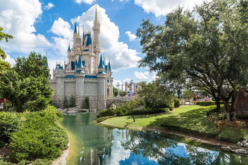 Orlando, Florida – Sept 4: The famous Disney Magic Kingdom Castle and its mirror reflection on the calm waters surrounding the castle in Orlando, Florida, on September 4, 2014, Orlando, USA, North America