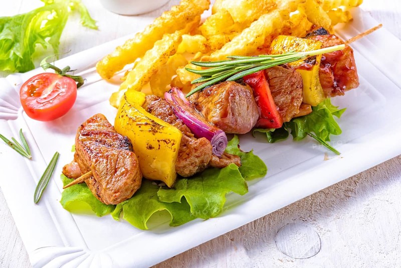 Shish kebab skewers with marinated ham meat paprika and red onion