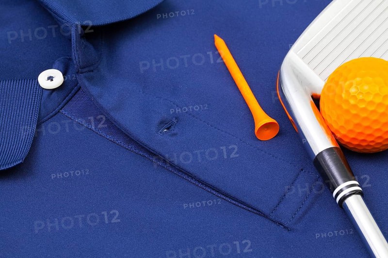 Detail of blue polo shirt and golf equipments