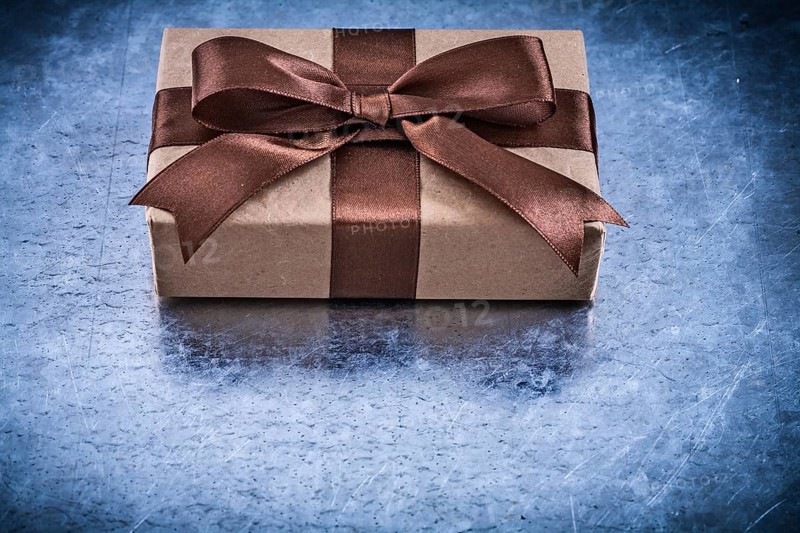 Packed gift boxes with brown ribbon horizontal version holidays concept
