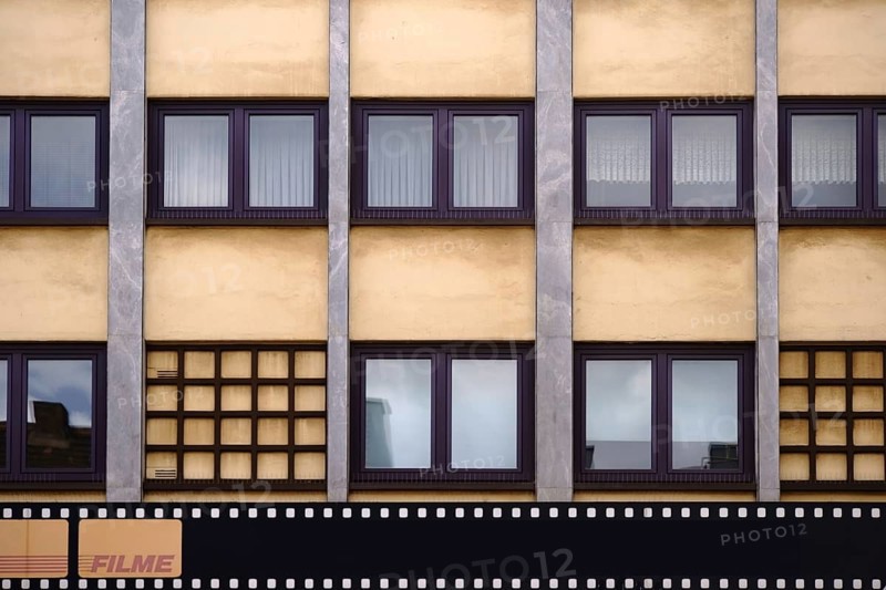 The exterior facade of a photo shop with a painted film strip