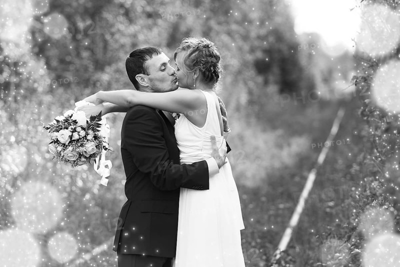 Bride and Groom embracing with happy smile on their faces