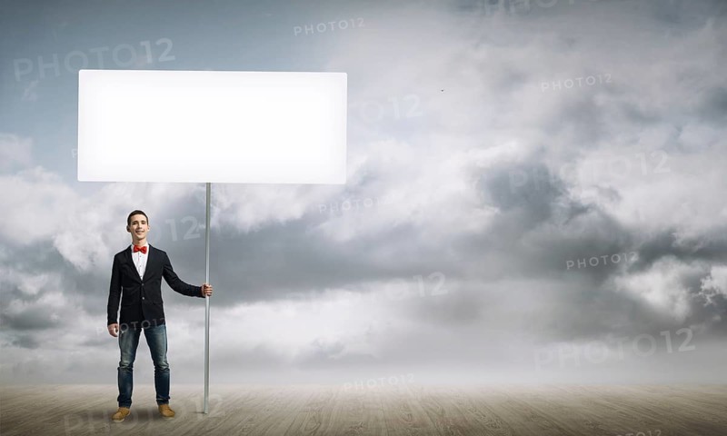 Fullbody of handsome guy holding white blank banner
