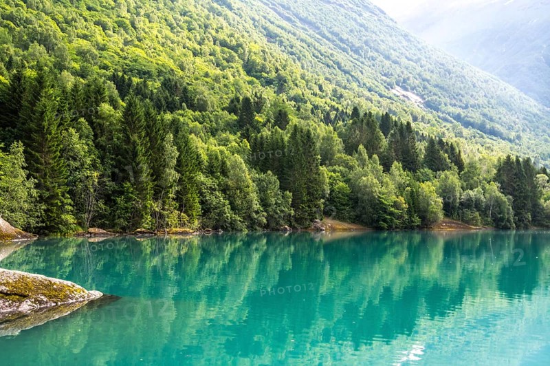 The Kjenndalsbreen is part of the Jostedalsbreen, one of the largest glaciers in Norway, and forms an impressive mountain landscape with a beautiful lake in Sande. The glacier Kjenndalsbreen with a lake in Norway is a beautiful place to travel to in summertime