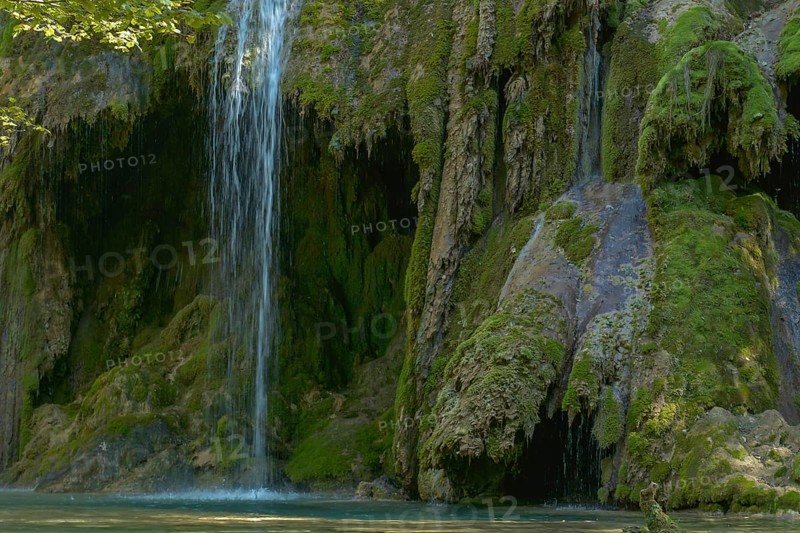 The tufa waterfall near Arbois. Crystal clear waterfall, powerful waterfall