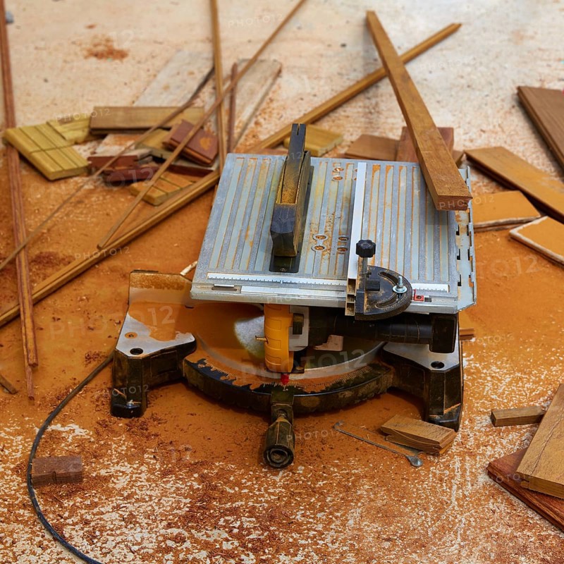 Circular table saw carpenter tool and sawdust in deck installation