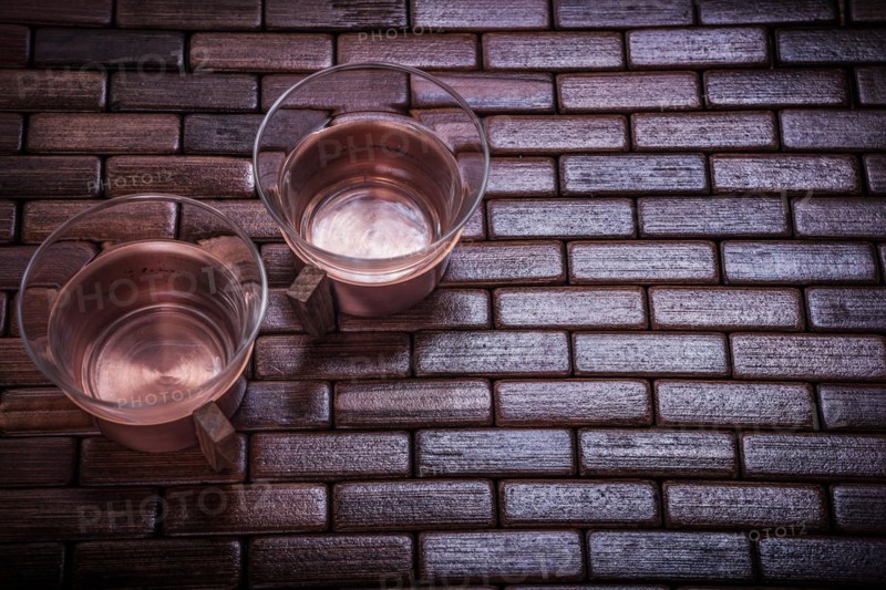 Coppery teacups on wooden mat Food and drink concept