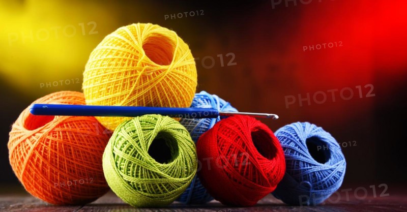 Composition with assortment of different colored yarns and hook for crocheting