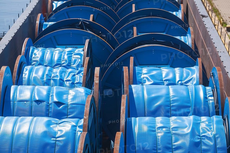 Inland waterway vessel with cargo of blue cable barrels, Hoya, Lower Saxony, Germany, Europe