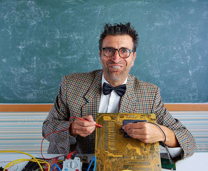 Nerd electronics technician retro teacher silly expression working in pcb