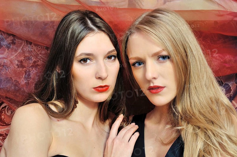 Portrait of the two beautiful women in an oriental interior