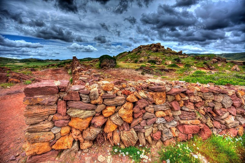 Masonry stonewall in spring with flowers at Menorca Balearic islands