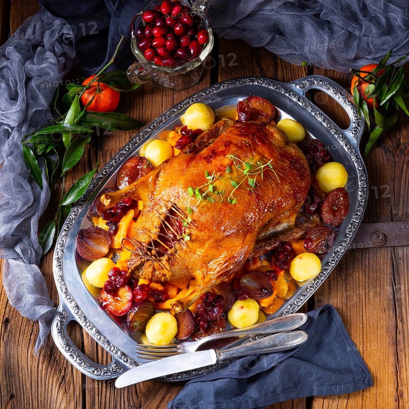 Roast duck with potato dumplings and plums