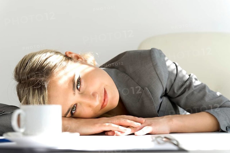 Young beautiful businesswoman sitting in the office. Break time with a cup of coffee, ST. Petersburg, Russia, Europe