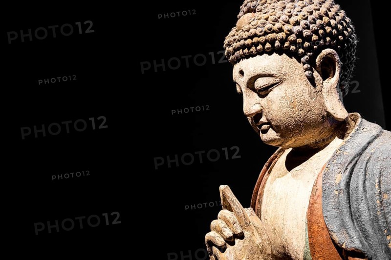Buddha Statue, Concept of Zen, Spirituality, Peace. Copy space on Black Background, texture light