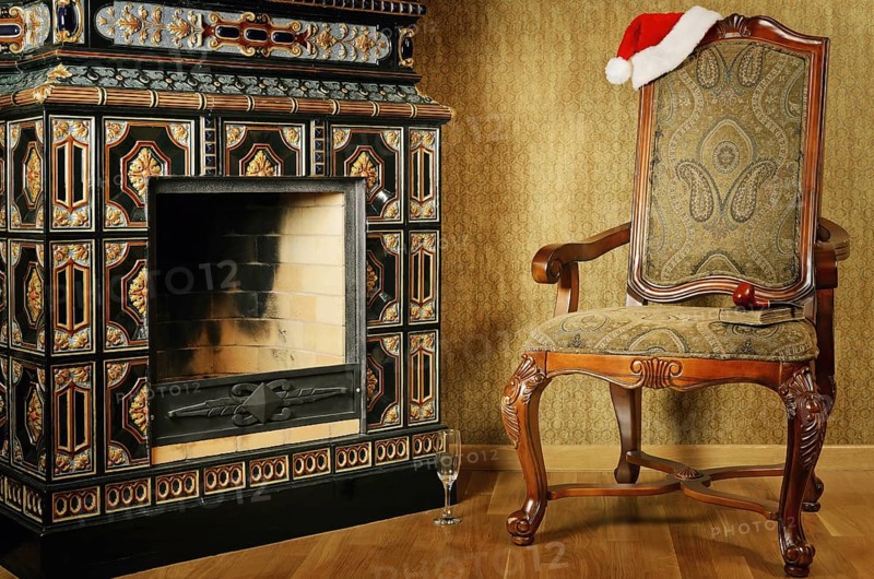 Old Antiques Armchair With Santa's Hat Near The Fireplace