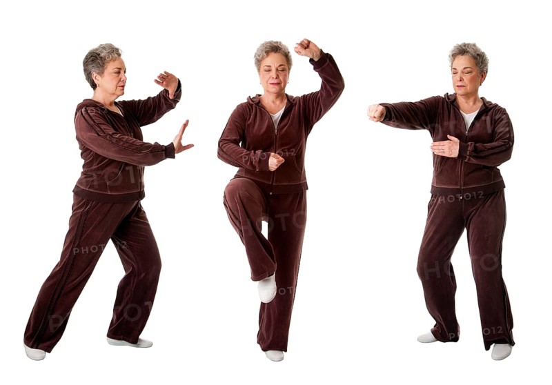 Beautiful Senior woman doing Tai Chi exercise to keep her joints flexible, isolated, New York, USA, North America