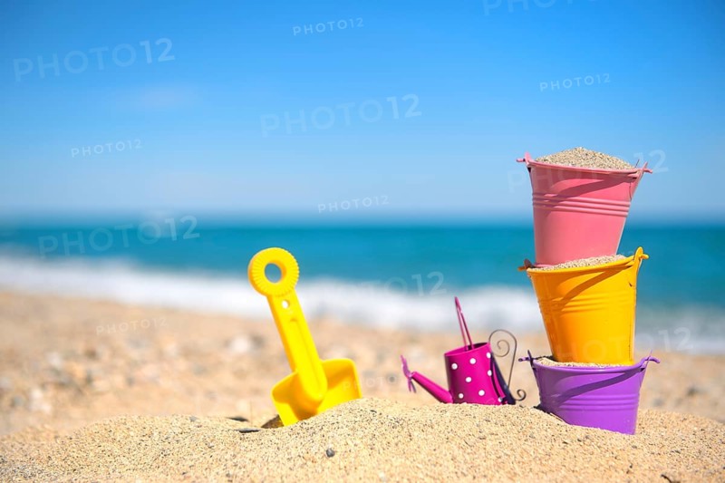 Colorful toy buckets at the beach