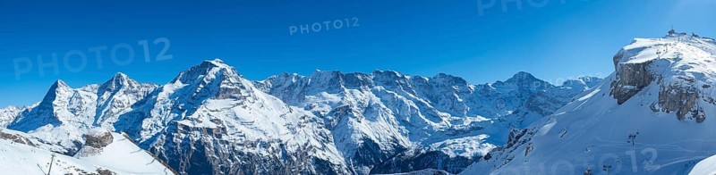 Various alpine peaks including Eiger, Moench, and Jungfrau, seen from the skiing resort Schilthorn high above Muerren, Switzerland, Europe