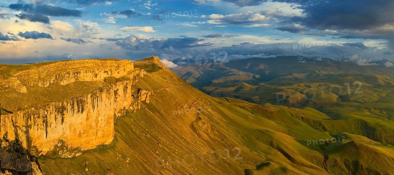 Aerial panorama view of plateau Bermamyt and hills at sunset, North Caucasus mountains, Russia, Europe