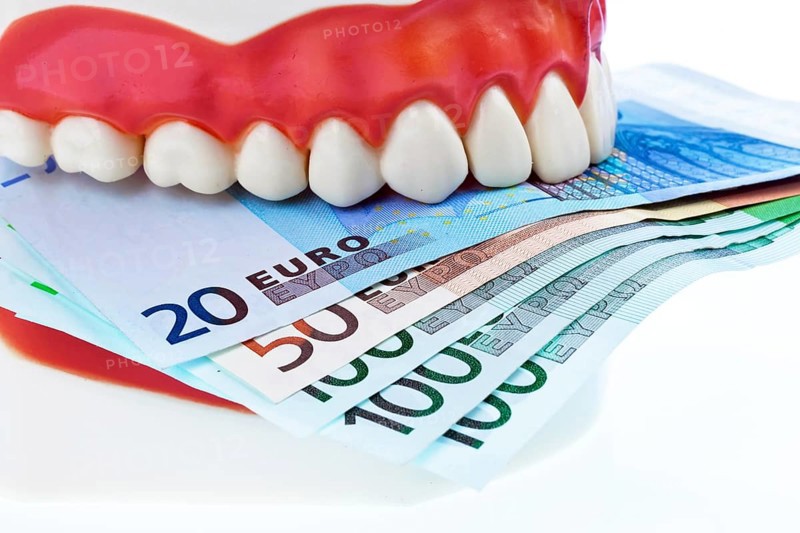 A dental model at the dentist with euro notes. Costs for health. Austria