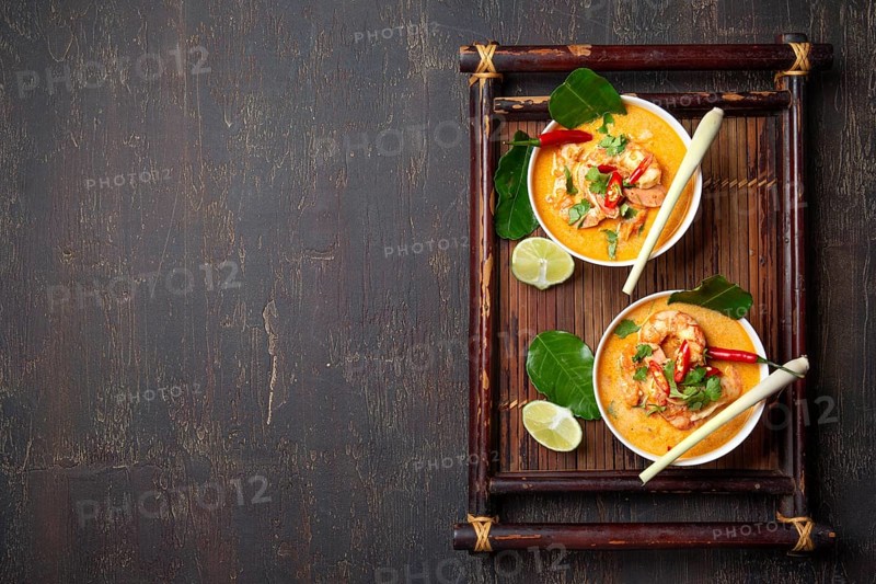 Food, Food, Shrimps Tom Yam Kung in grey bowl with thai spices on autentic tray top view, wooden background