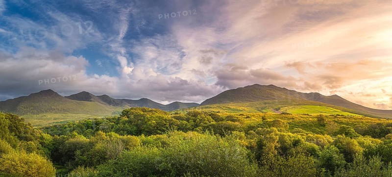 Large panorama with amazing sunset and dramatic sky at the foothill of Carrauntoohil mountain, MacGillycuddys Reeks mountains, Ring of Kerry, Ireland, Europe