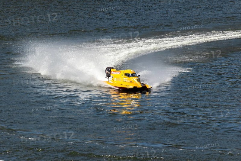 PESO DA REGUA, PORTUGAL - SEPTEMBER 15, 2024: Yellow Powerboat Makes Sharp Turn with Splashes of Water during Race. Formula 2 World Championship