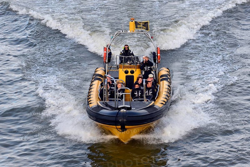 Speedboat with several people travelling at high speed across the water, London, London region, England, United Kingdom, Europe