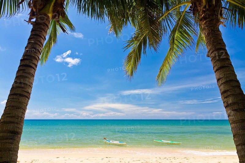 Sand beach with palms and canoes in Phu Quoc close to Duong Dong, Vietnam, Asia