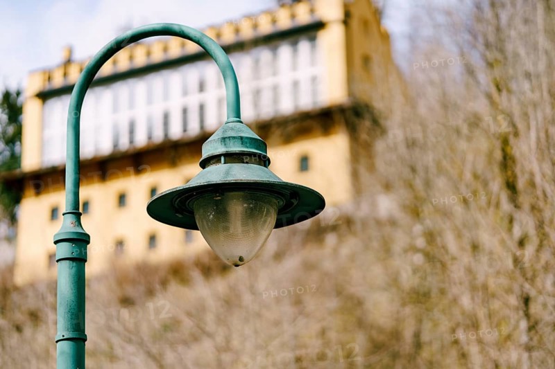 An old street lamp on a metal pole.