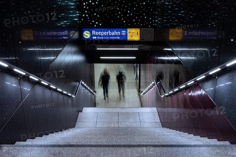 Entrance to the Reeperbahn underground station while two people walk down the stairs, St. Pauli, Free and Hanseatic City of Hamburg, Germany, Europe