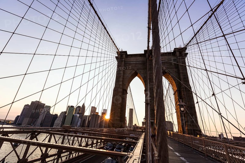 Brooklyn Bridge sunset with Manhattan skyline of New York City USA