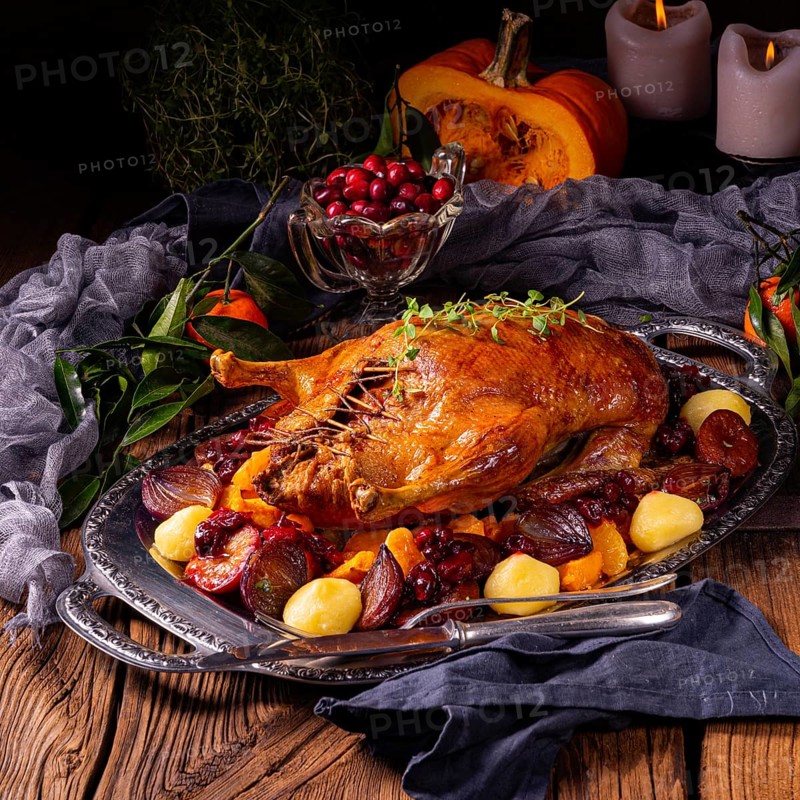 Roast duck with potato dumplings and plums