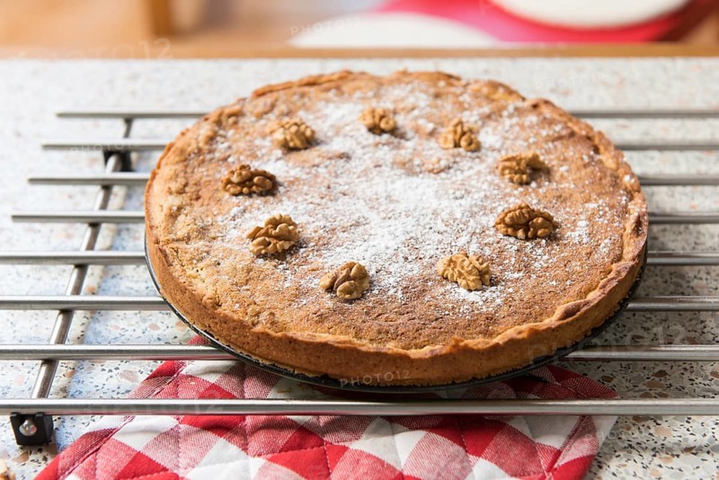 Baked walnut cake in kitchen