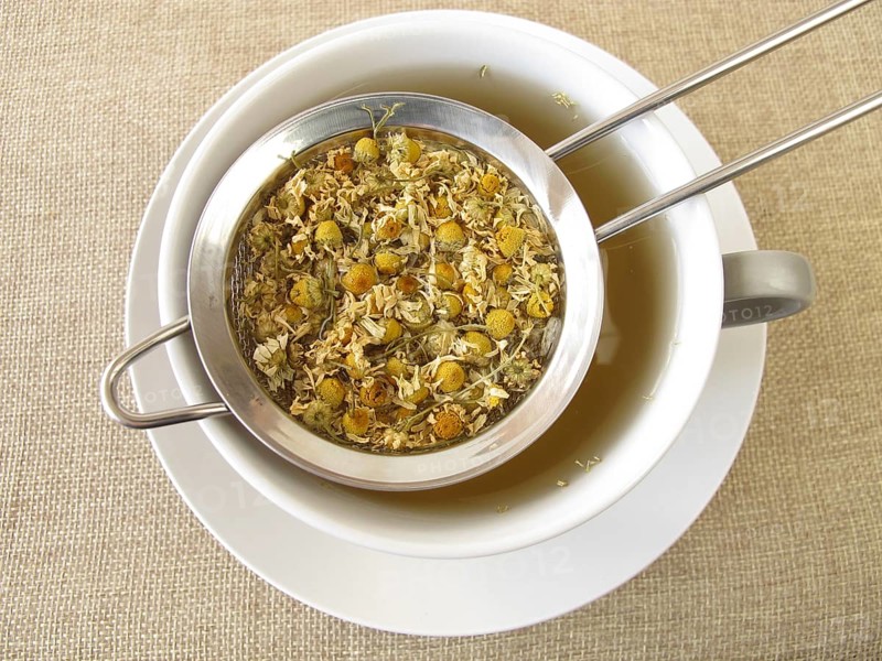 Camomile tea in a tea strainer