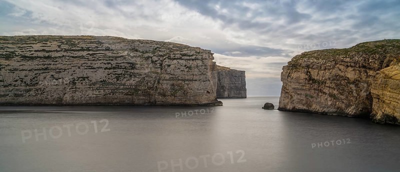 A panorama landscape view of Dwejra Bay and Ufo Rock on Gozo Island in Malta