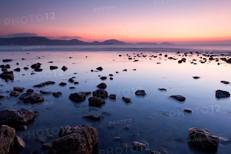 Colorful sunrise on the rocky sea coast