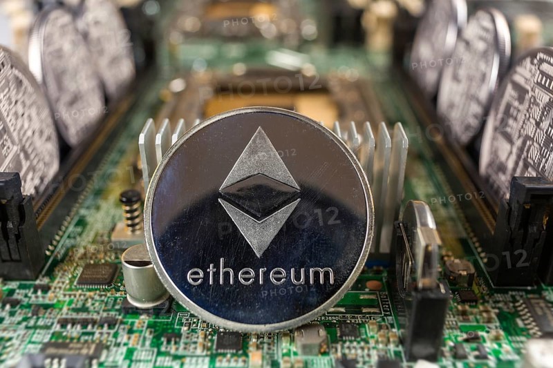 Ethereum coin close-up on a computer circuit motherboard as a blockchain technology payment network. Digital cryptocurrency concept and mining