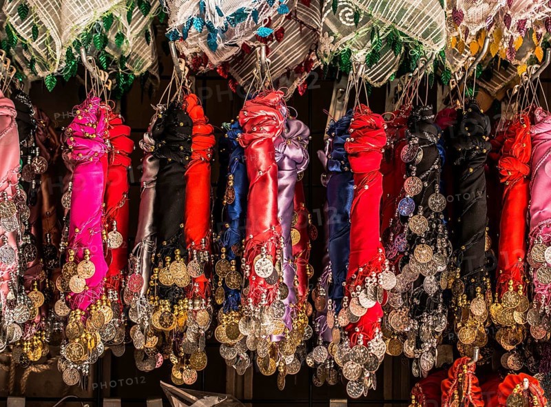 Plenty of fake gold coins are on the scarf edges