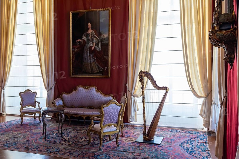 Venaria Reale, Italy, February 2023: luxury interior, old Royal Palace. Perspective with harp, window and baroque decoration, Europe