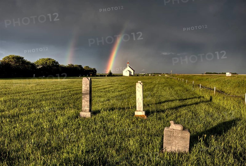 Old Country Church in Saskatchewan Canada with storm clouds rainbow