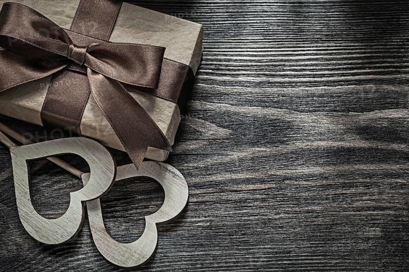 Present box white wooden hearts on vintage wood board celebrations concept