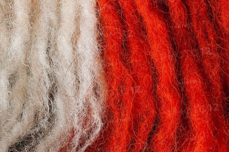 White and red wool fibers closeup