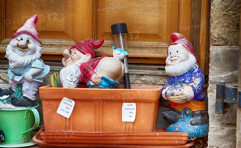 Garden gnomes in front of a door in a French village, 2019