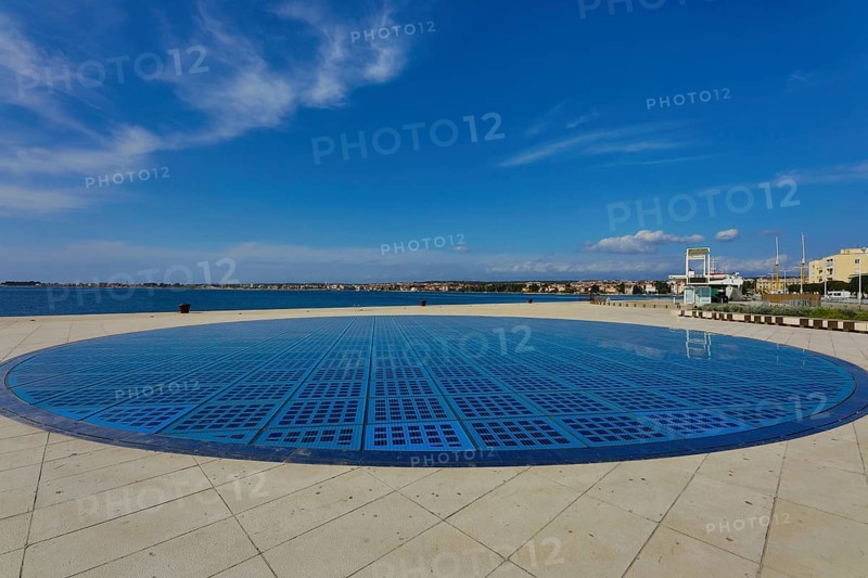 Modern circular solar installation by the sea with clear sky and calm surroundings, artwork Greeting to the sun Zadar Dalmatia Croatia